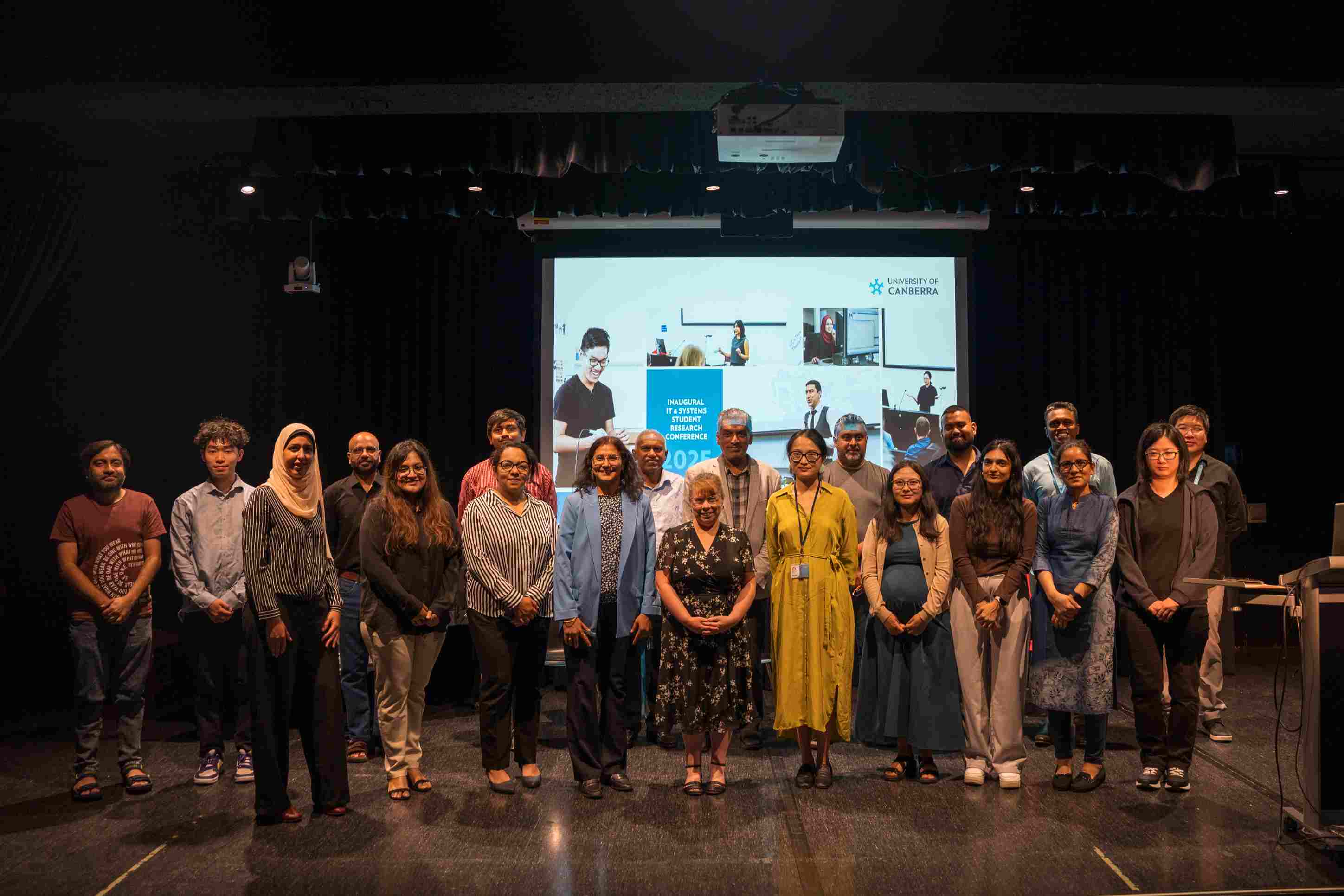 A large group of people posing together for a photo indoors.