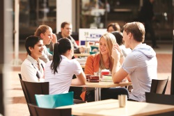 domestic students sitting at a table having a discussion