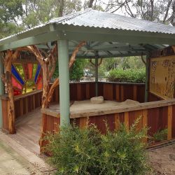 Semi enclosed sand pit structure for year round use