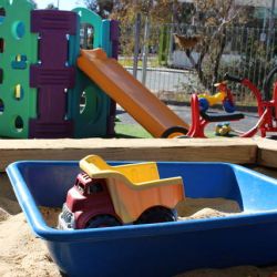 toy truck in a sunny sandpit